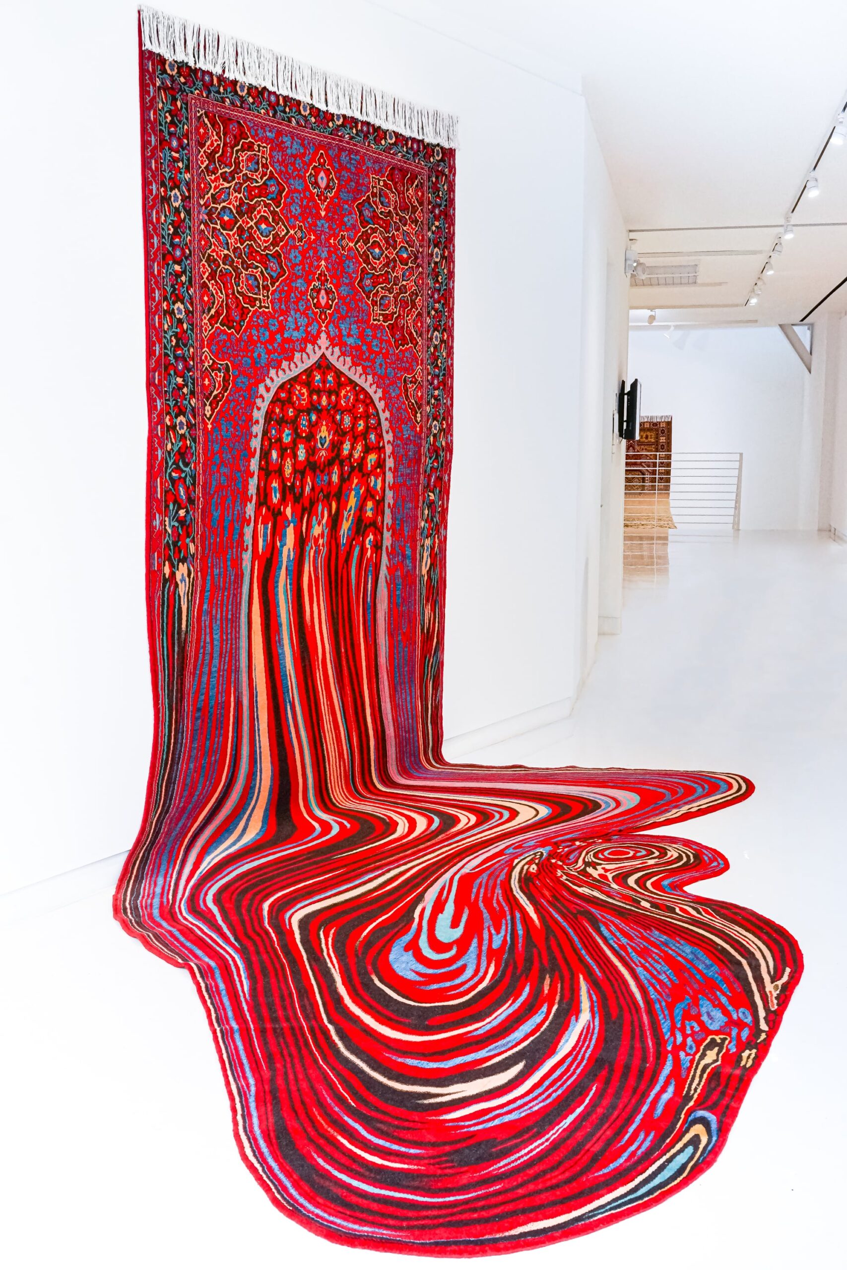 Sierlijke tapijten van kunstenaar Faig Ahmed sijpelen op de vloer in druipende stoffen plassen
